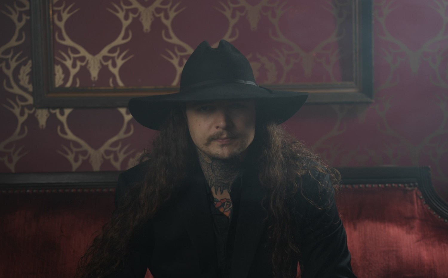 Kade Isakson looking into the camera with a big black hat on